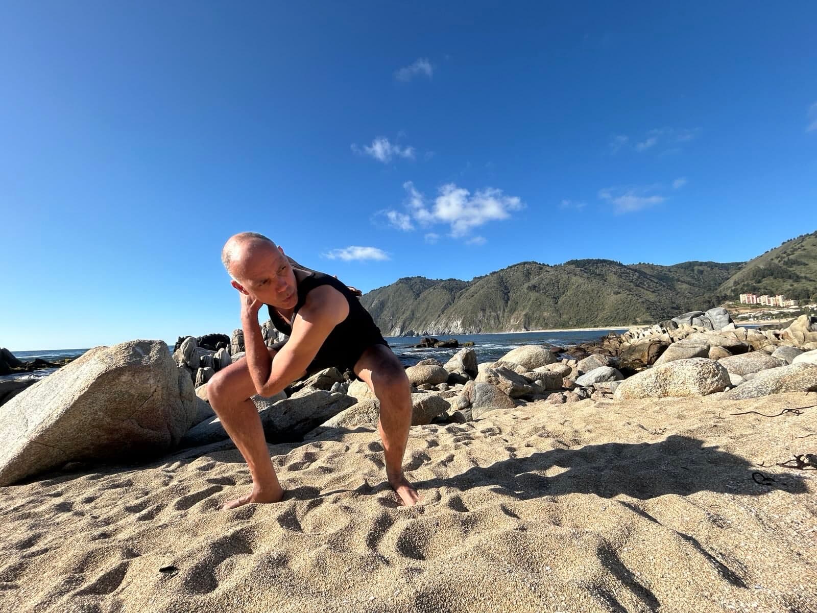 Rene in a wide-stance maneuver on a rocky coastline